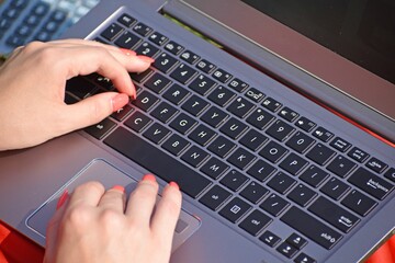 Closeup of a woman's hands using laptop