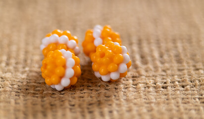 Bright orange textured beads with a white stripe