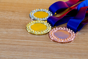 Three medals on wooden table