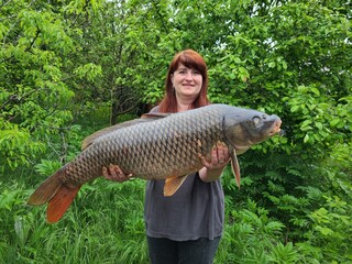 Woman holding a big carp