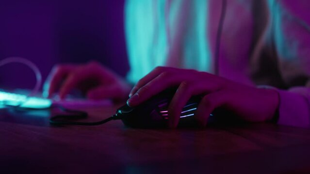 Detail of computer mouse used by gamer at night. Shot with RED helium camera in 8K.  