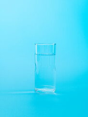 A glass of water on blue background
