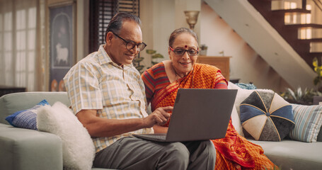 Elderly Couple Using Laptop at Home: Exploring New Interests, Discovering Online Communities, and...