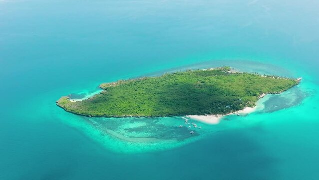 Aerial view of small island with beach and blue sea. Virgin Island, Philippines.