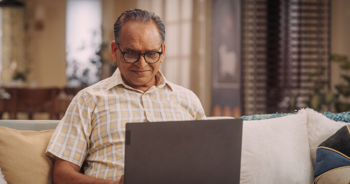 Indian Man Using Laptop: Exciting Online Adventures, Broadening Horizons, Sparking Joy Through Digital Exploration. Engaging And Connecting With People Sharing Interests.Medium Close-up .