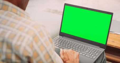 Over-the-Shoulder View of Elderly Indian Gentleman Using Laptop with Green Screen: Doing Remote Work, Virtual Meetings. Browsing Internet, Doing Online Shopping, Using Software. Template Chroma Key