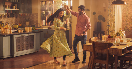 Young Couple Dancing and Having Fun in the Kitchen. Boyfriend and Girlfriend Sharing Moment of Love...