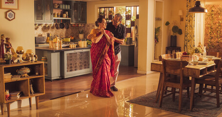 Elderly Couple DancingKitchen and Enjoying Each Other's Company: Moving to the Rhythm of Music and Love, With Smiling Faces and Loving Embrace, Celebrate Anniversary