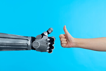 Human hand and robot finger thumbs up