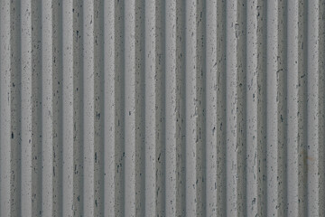 grey concrete wall with deep textured 3d lines vertical, diagonal or horizontal with a lot of copy space for text background