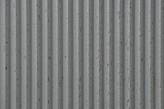 grey concrete wall with deep textured 3d lines vertical, diagonal or horizontal with a lot of copy space for text background