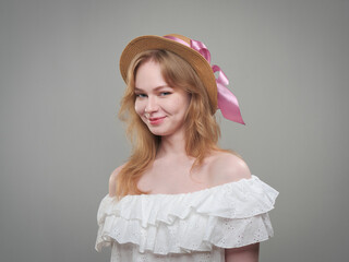 portrait of a beautiful girl with blue eyes on a gray background in the studio