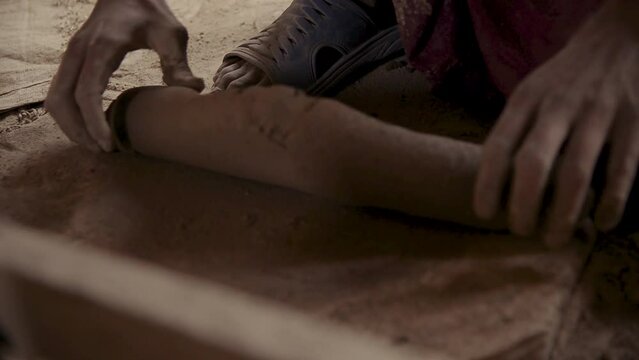 A Man Kneading Clay for Pottery close up hand