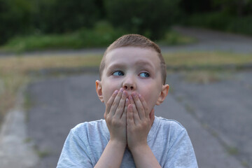 Fototapeta premium Preschooler standing with surprise expression at park