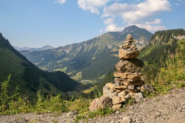 Hill of stones on the peak with rocky mountains in the background