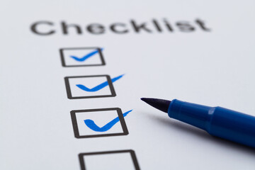 Blue pen marking on checklist sheet