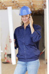 happy woman builder on the phone