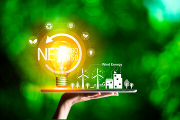 Hand holding with  green energy, solar energy system icon on blur green leaf. solar energy for eco...