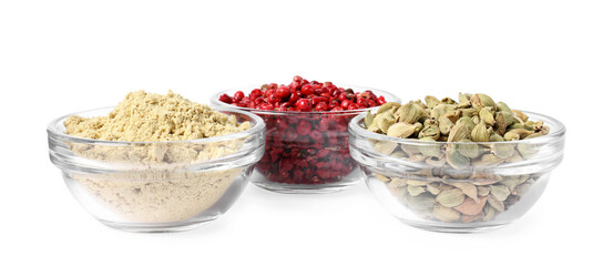 Bowls with dried cardamom, ginger root powder and red peppercorns on white background
