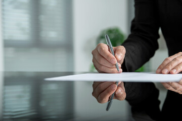 Businesswoman hand writing on paper