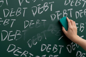 Hand erasing word debts on blackboard