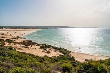 Beautiful shot of a sunny rocky seashore on a summer day in Kef Abbed, Tunisia
