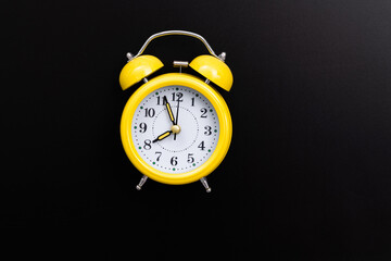 Alarm clock on black chalkboard