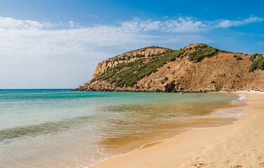 Beautiful shot of a sunny rocky seashore with a cliff on a summer day in Kef Abbed, Tunisia
