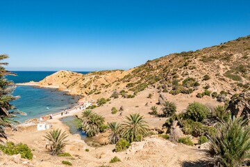 Sandy mountains with green vegetation on the coast of Korbous, Tunisia