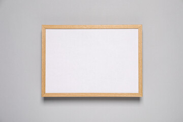 Empty photo frame on light background, top view. Space for design
