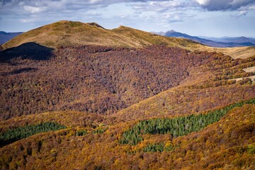 Drone shot of hills covered with autumn forests, cool for background