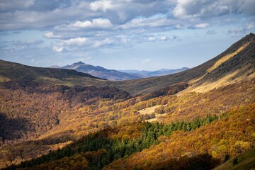 Drone shot of hills covered with autumn forests, cool for background
