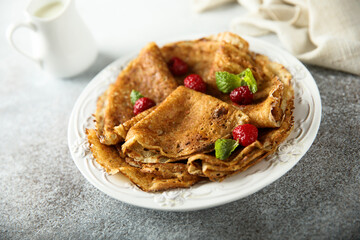 Traditional homemade crepes with raspberry