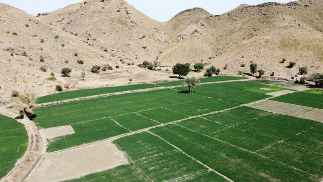 green field Aerial Flying Over Remote Road Through Mountainous Valleys In Khuzdar.