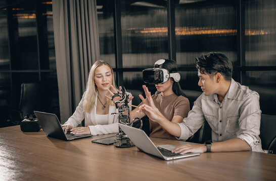 College students collaborate with research team to do experiment with educational robots. Wearing virtual reality goggle help learner to engage real, interacting situations with immersive experience.