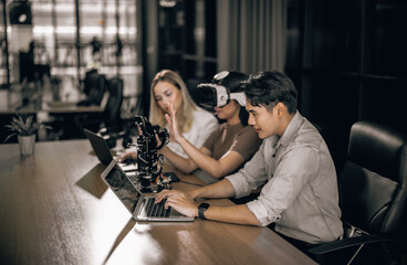 College students collaborate with research team to do experiment with educational robots. Wearing...