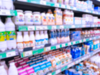 Abstract blur image of supermarket background. Defocused shelves with dairy produce, food. Grocery shopping. Store. Retail industry. Rack. Discount price. Inflation. Economic crisis concept. Aisle.