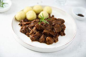 Homemade beef ragout with potato dumplings