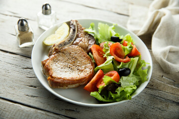 Baked pork chop with vegetable salad