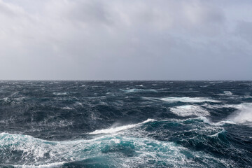 Beautiful seascape - waves and sky with clouds with beautiful lighting. Stormy sea, Bad weather. Gale. Rough sea.
