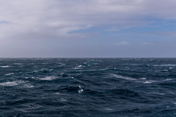 Beautiful seascape - waves and sky with clouds with beautiful lighting. Stormy sea, Bad weather. Gale. Rough sea.