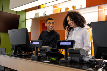 Team of receptionists working at the hotel reception desk
