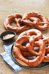 Oktoberfest concept card. Traditional Bavarian pretzels with beer bottle mug on old rustic wooden background. Perfect for Octoberfest. Oktoberfest food menu. Top view. Mock up.