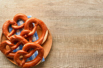 Oktoberfest concept card. Traditional Bavarian pretzels with beer bottle mug on old rustic wooden background. Perfect for Octoberfest. Oktoberfest food menu. Top view. Mock up.