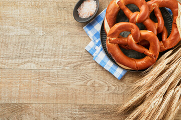 Oktoberfest concept card. Traditional Bavarian pretzels with beer bottle mug on old rustic wooden background. Perfect for Octoberfest. Oktoberfest food menu. Top view. Mock up.