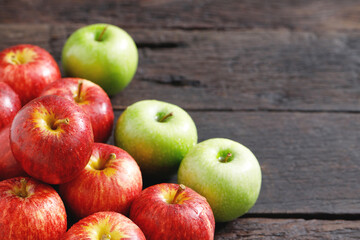 fresh red and green apples on the wooden floor