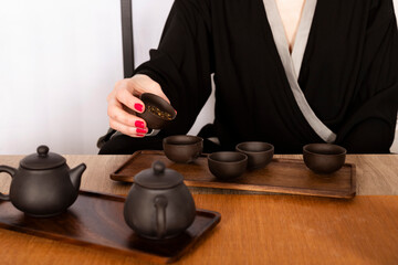 Attractive white girl in kimono and Hair sticks drinks tea in japanese style. Japanese tea ceremony.