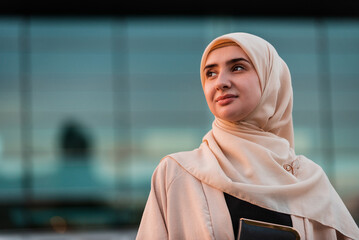 Portrait of a Muslim business woman in hijab near the office building.