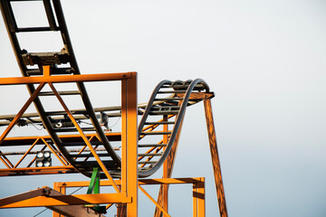 Close up of a roller coaster in amusement park Prater, Vienna with blue sky in the background