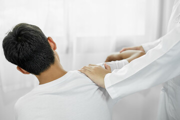 patients with shoulder injuries massaging their shoulders for muscle recovery in the rehabilitation...